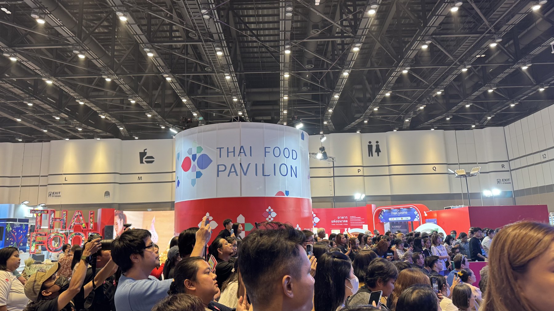 Food, travel and public expo floor with crowds and national pavilions.
